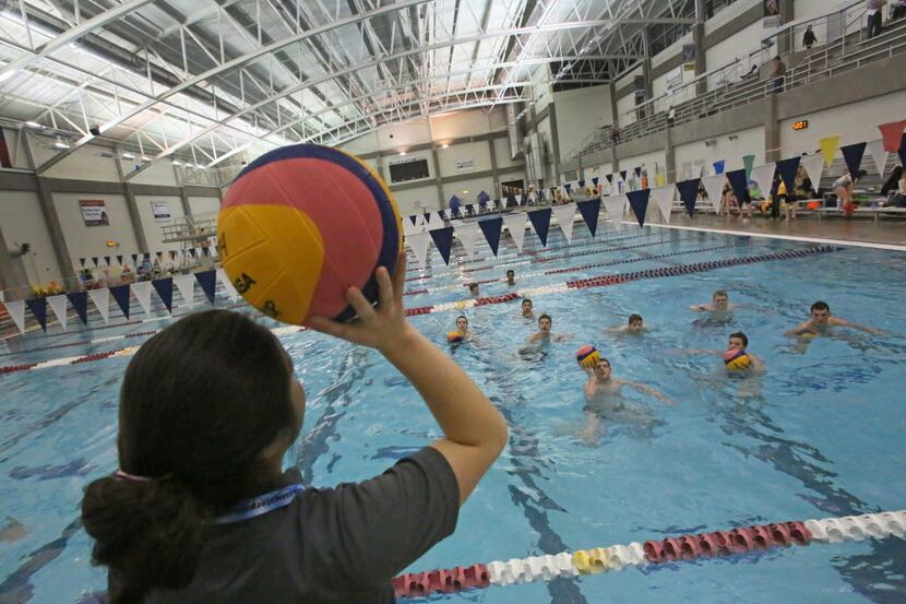 Coach Angela Uno works with the boys team during homeschool high school water polo practice...