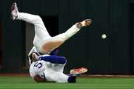 Texas Rangers second baseman Marcus Semien (2) and right fielder Adolis Garcia (53) collide...