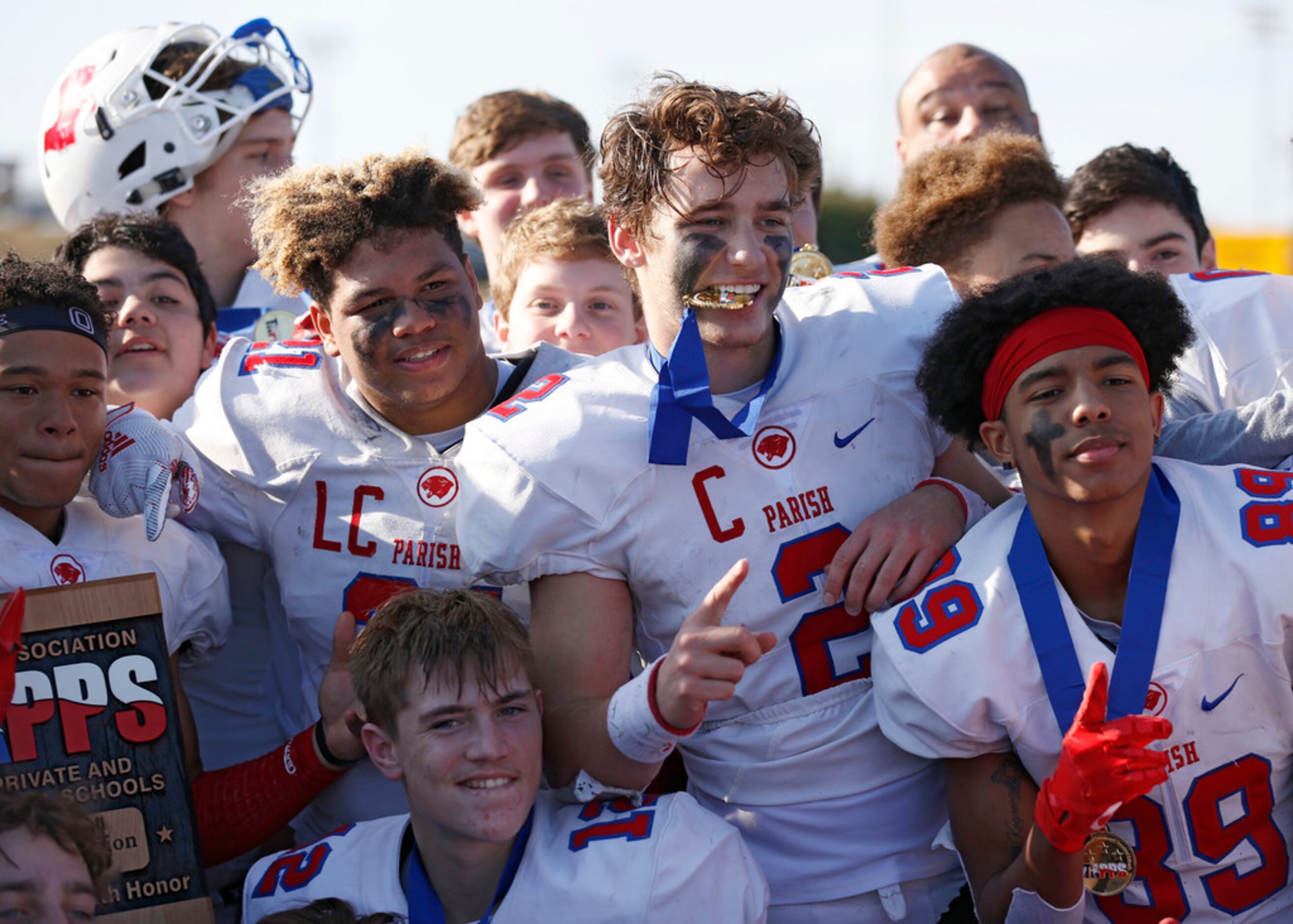 Parish Episcopal's Preston Stone (2) and teammates celebrate their victory over Plano John...