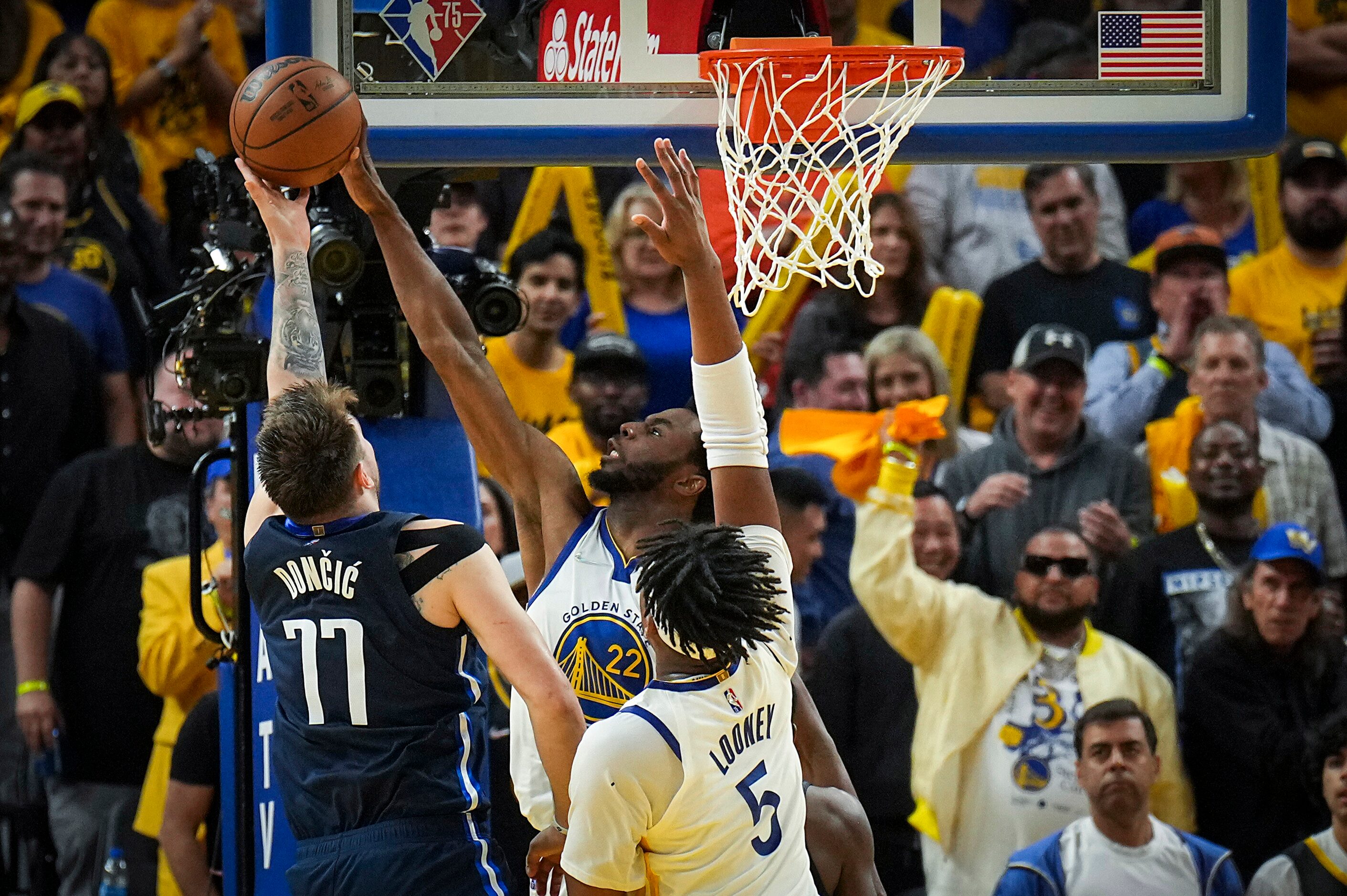 Golden State Warriors forward Andrew Wiggins (22) blocks a shot by Dallas Mavericks guard...