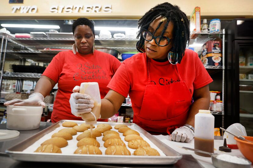 Deidra Keener (right) decorates deluxe sweet potato cookies alongside her sister Yolanda...