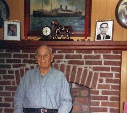 Thomas Cummings Sr., a World War I veteran, poses in front of his living room fireplace,...