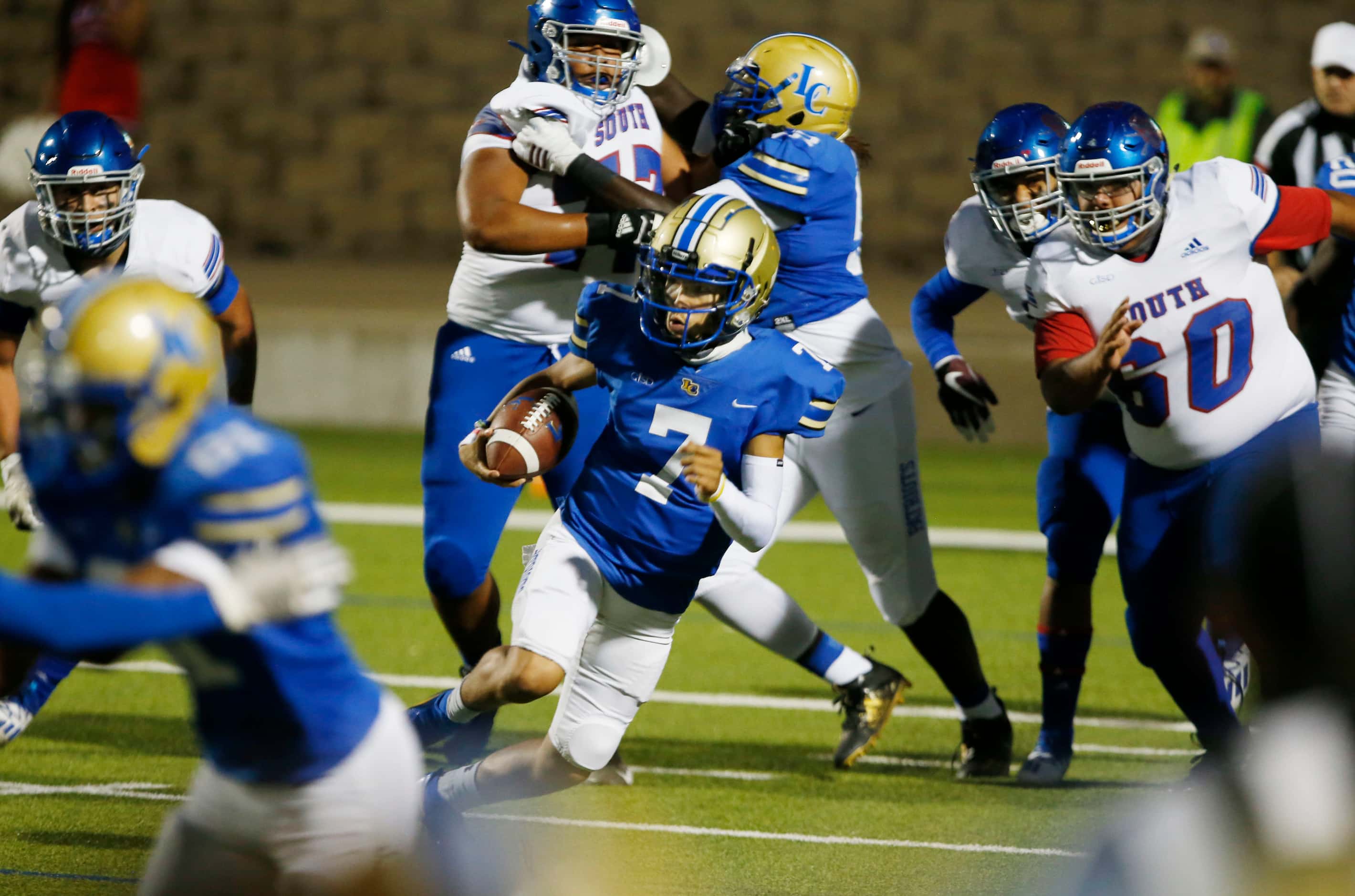 Lakeview QB Michael Hierro (7) looks for running room in a crowd, while scrambling during...