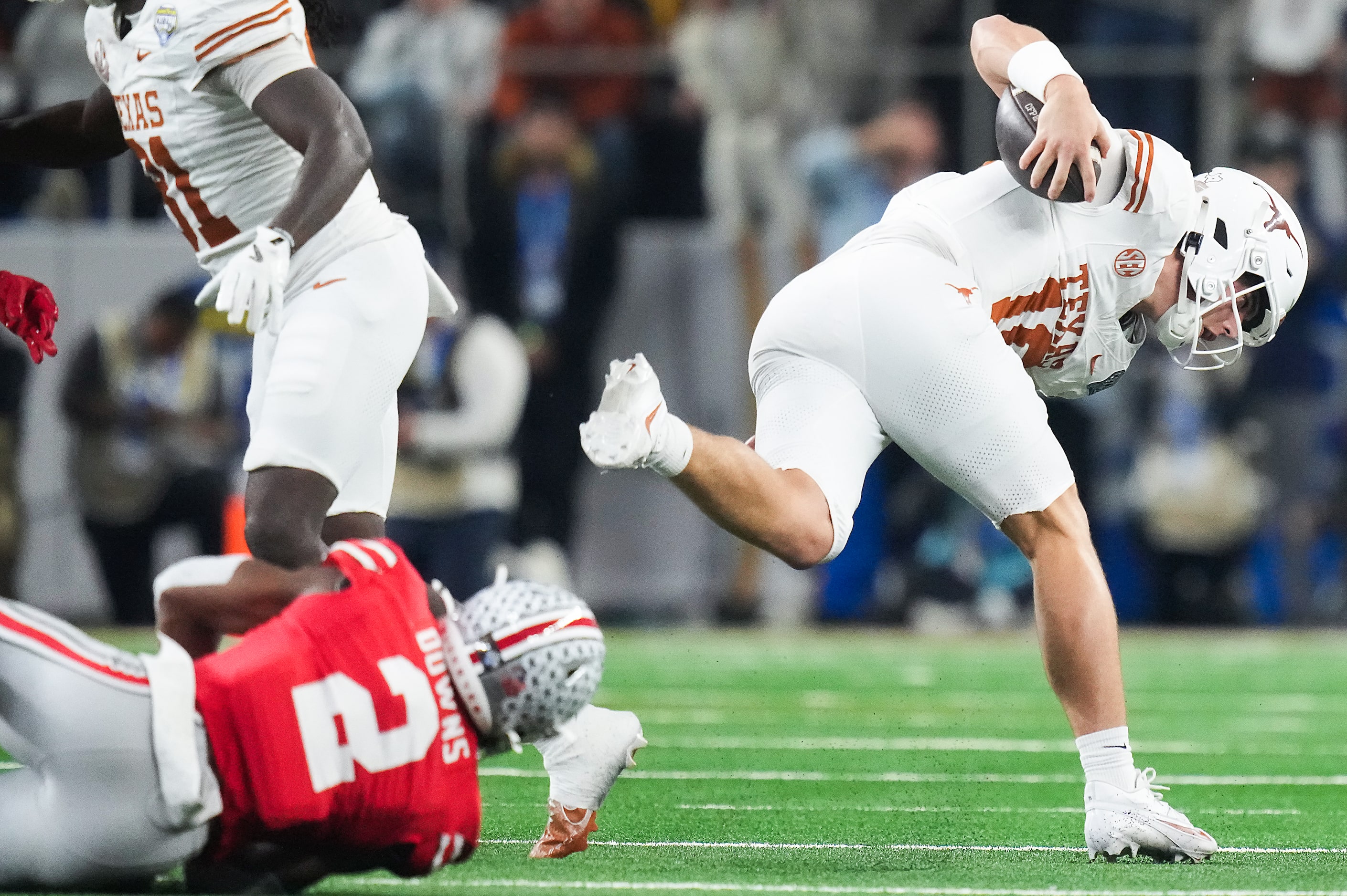 Texas quarterback Arch Manning (16) picks up a first down on a fourth-and-one past Ohio...