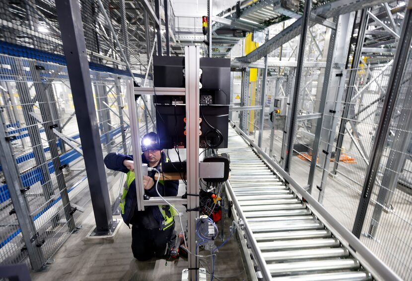 Electrician Igor Meocec builds out a computer work station in the area of the perishable...