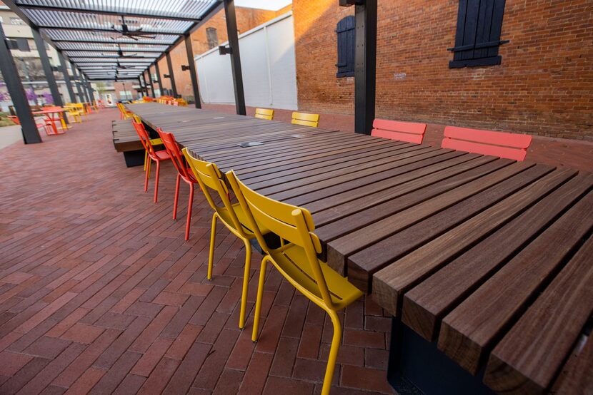 The communal work table with charging stations at the West End Square park in Dallas on...