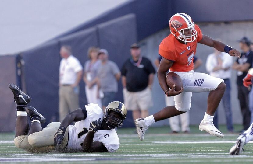 UTEP quarterback Kavika Johnson just avoids Army's Andrew King of Army during an NCAA...