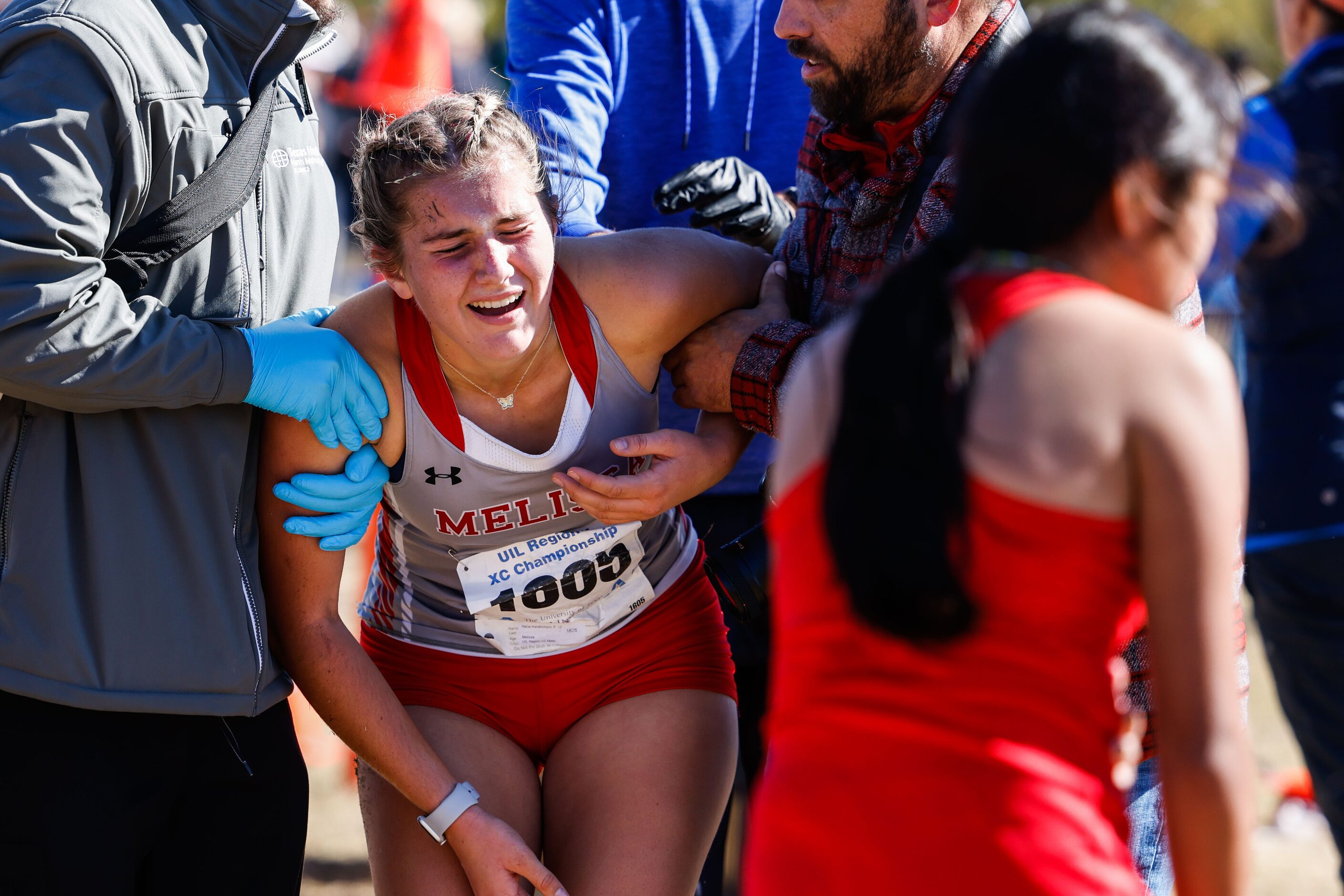 Hallie Hendrickson (1605) from Melissa team collapses after crossed the finish line during...