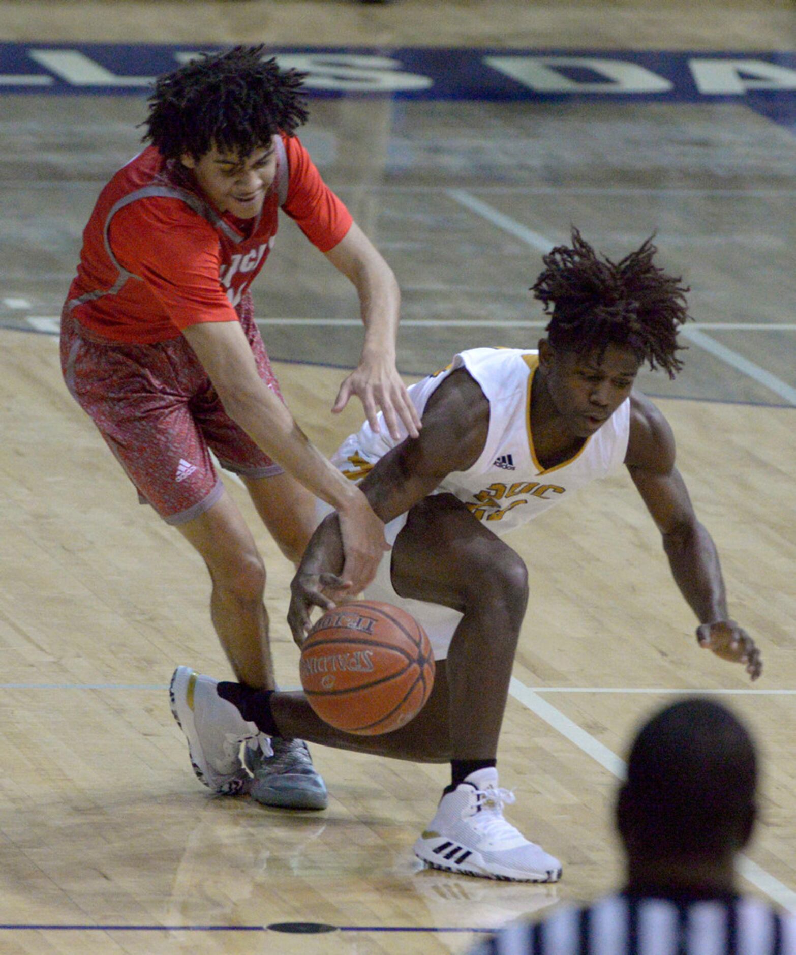 Woodrow Wilson's Grant Goosby (in red) goes after a loose ball with South Oak Cliff's...