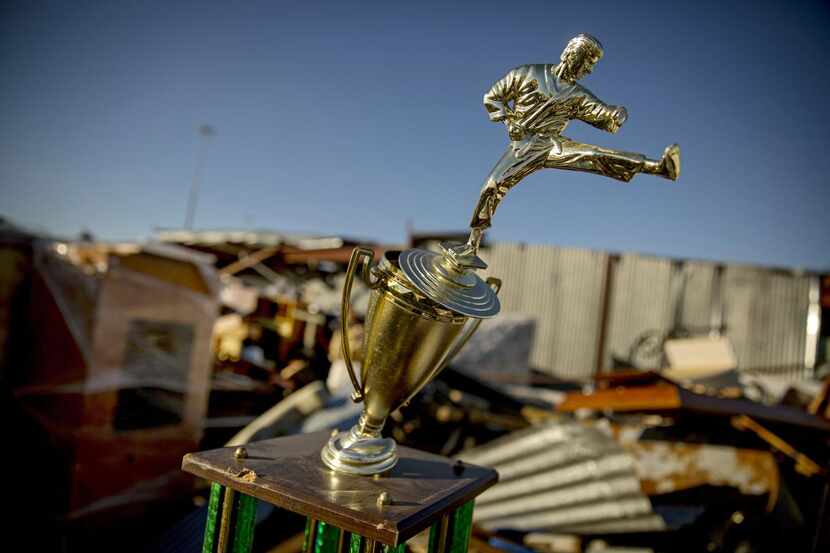 An off-kilter  martial arts trophy and so many other mementos were battered in the Dec. 26...