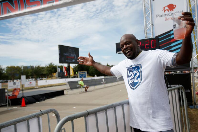 Former Cowboys running back Emmitt Smith's cheers at the finish line during his Gran Fondo...