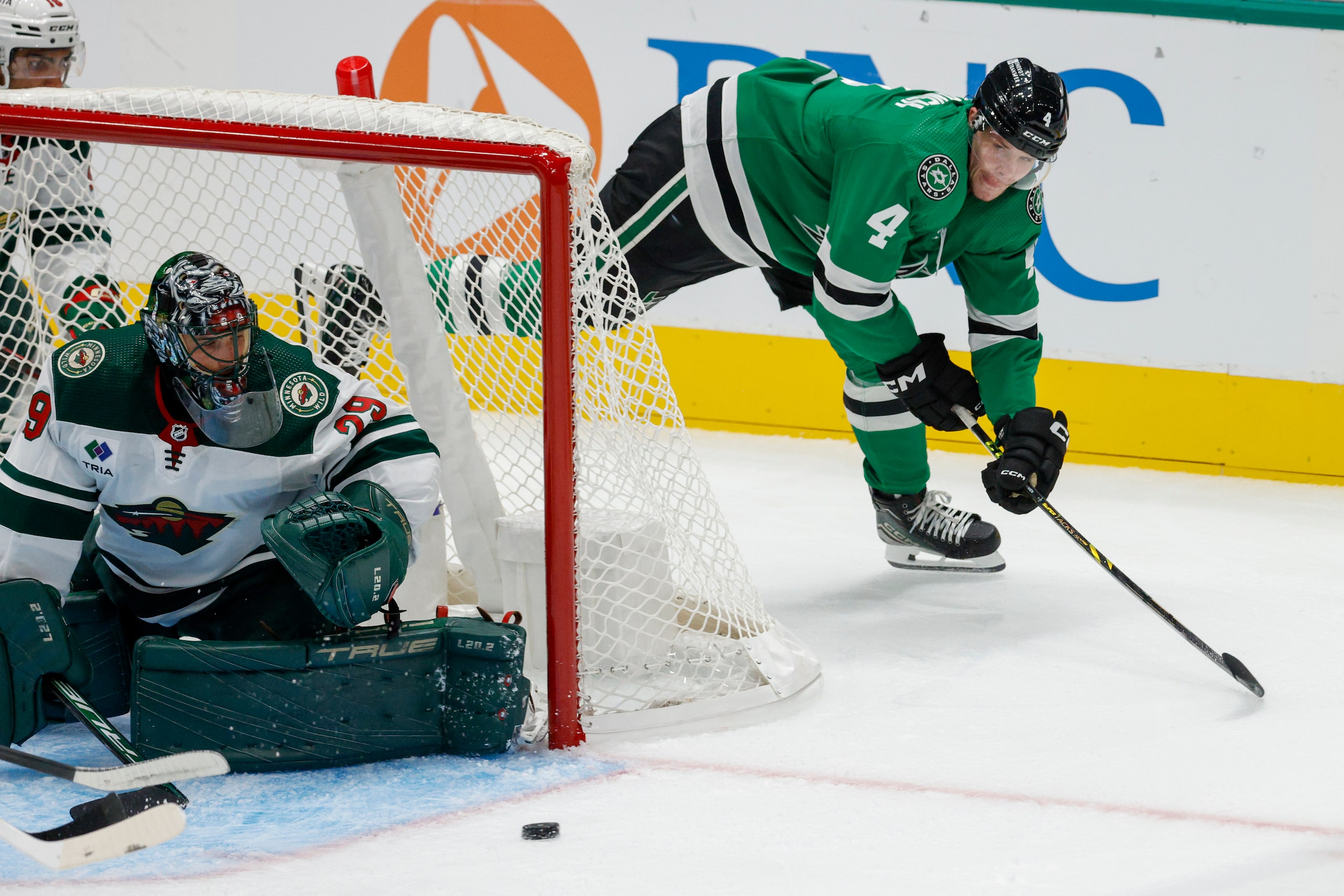 Dallas Stars defenseman Miro Heiskanen (4) passes the puck past Minnesota Wild goaltender...