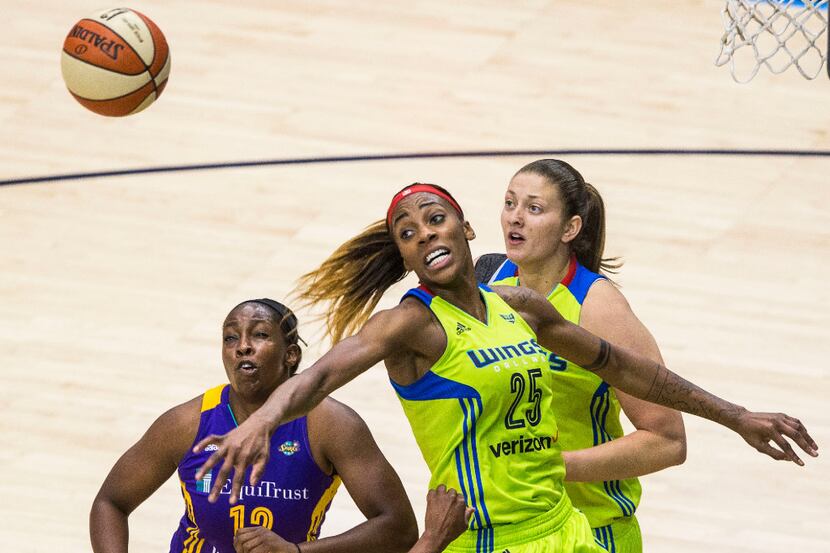Dallas Wings forward Glory Johnson (25, middle) and forward Theresa Plaisance (right) and...