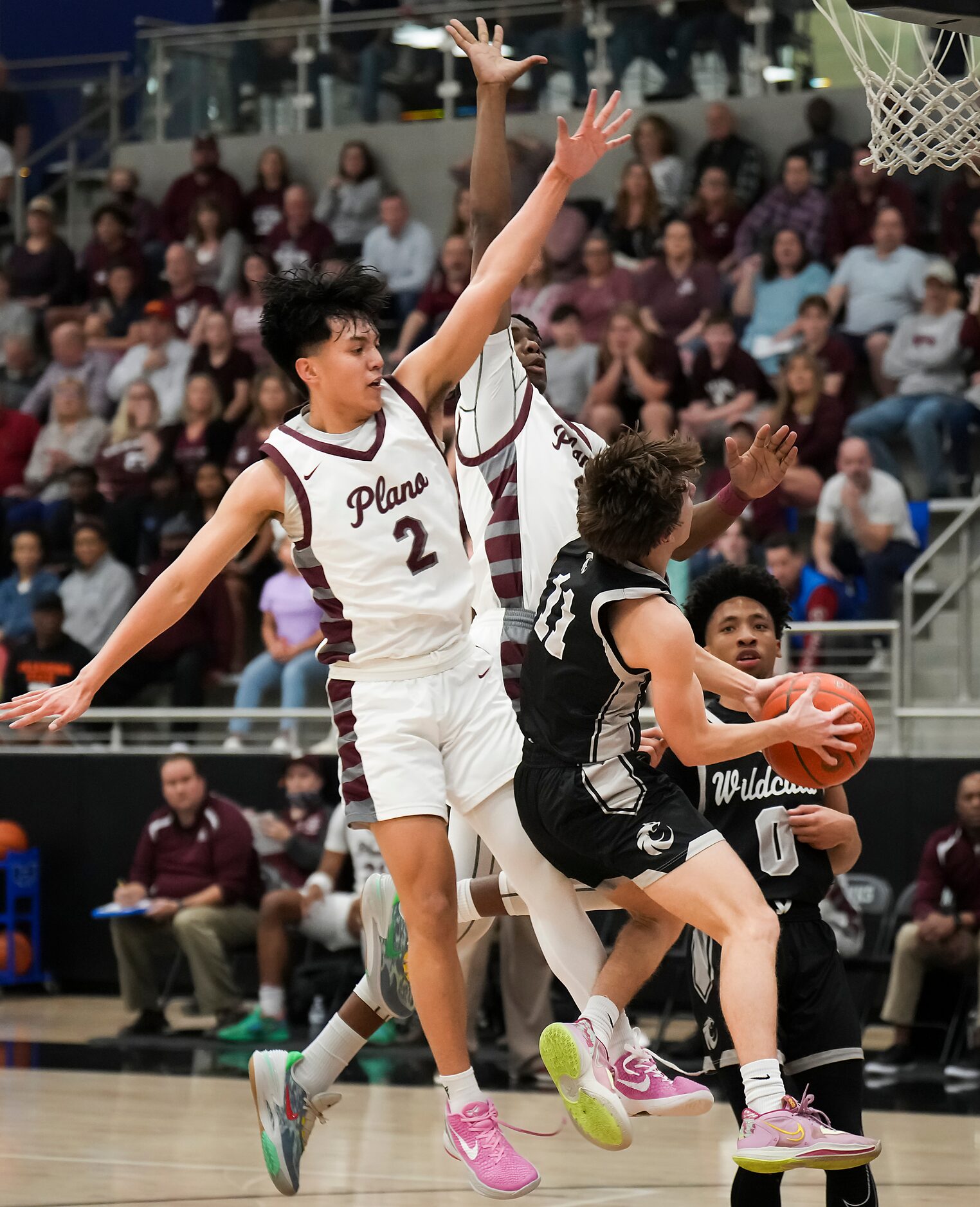 Plano guard Justin Buenaventura (2) and guard Tyran Mason (1) defend a drive to the basket...