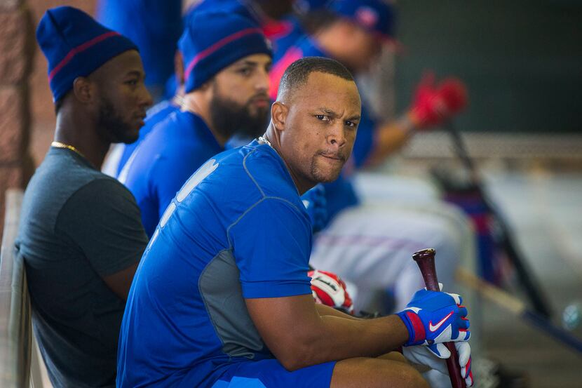 Texas Rangers third baseman Adrian Beltre waits his turn in the batting cage before a spring...