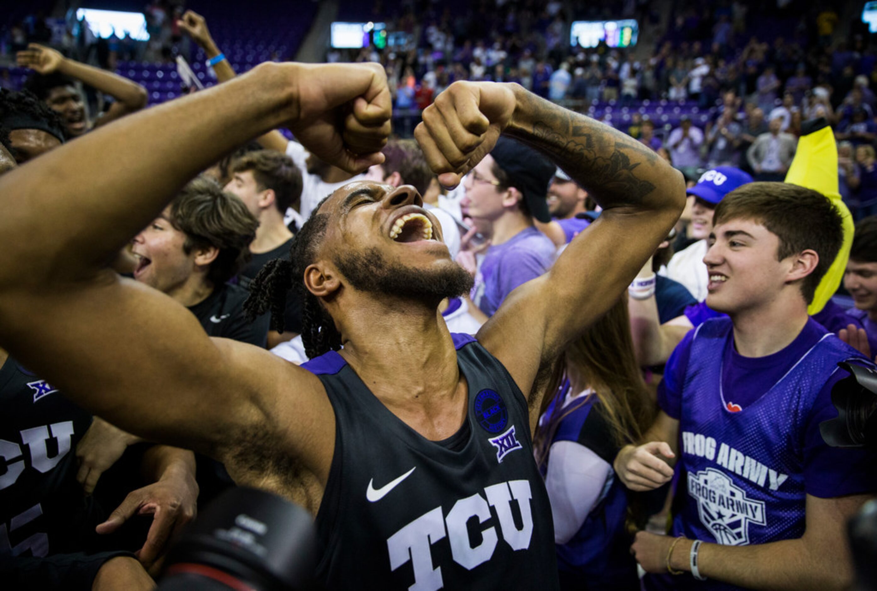 TCU Horned Frogs guard PJ Fuller (4) celebrates after fans rush the court because of a 75-72...