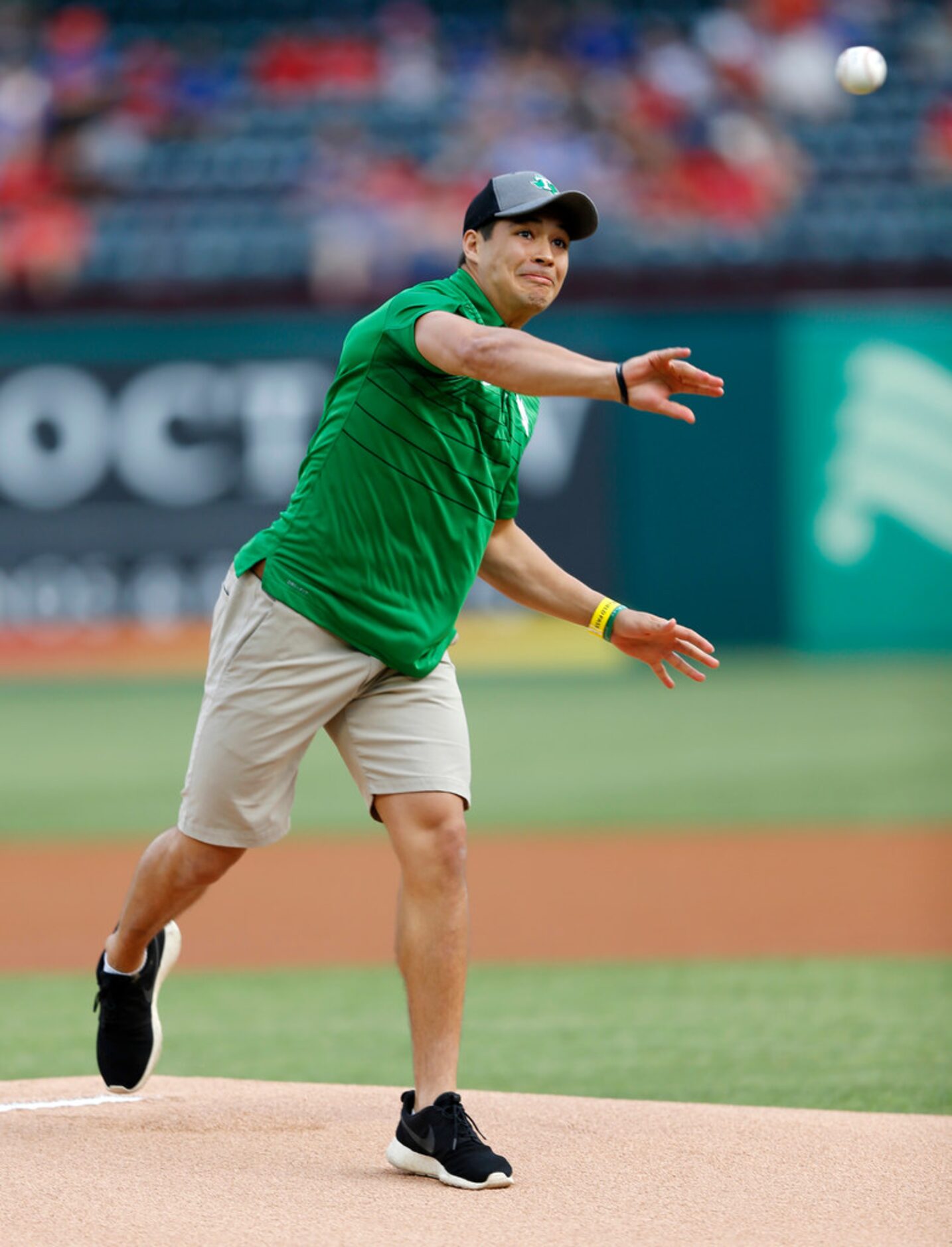 University of North Texas' quarterback Mason Fine throws the first pitch before a game...