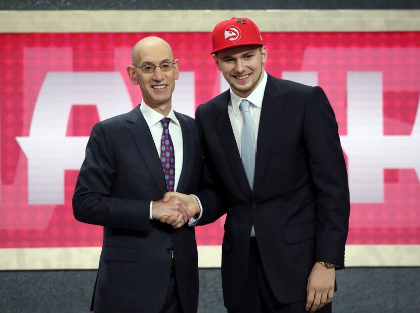 Luka Doncic, who plays for Real Madrid, poses for a picture with NBA Commissioner Adam...