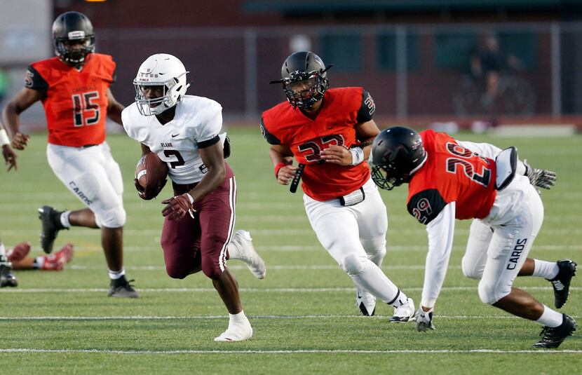 TXHSFB Plano junior running back Kyron Cumby (2) eludes the Irving MacArthur defense to...