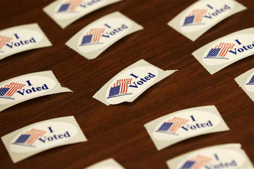 I Voted stickers sit on a table during early voting for the Nov. 6th election, Wednesday,...