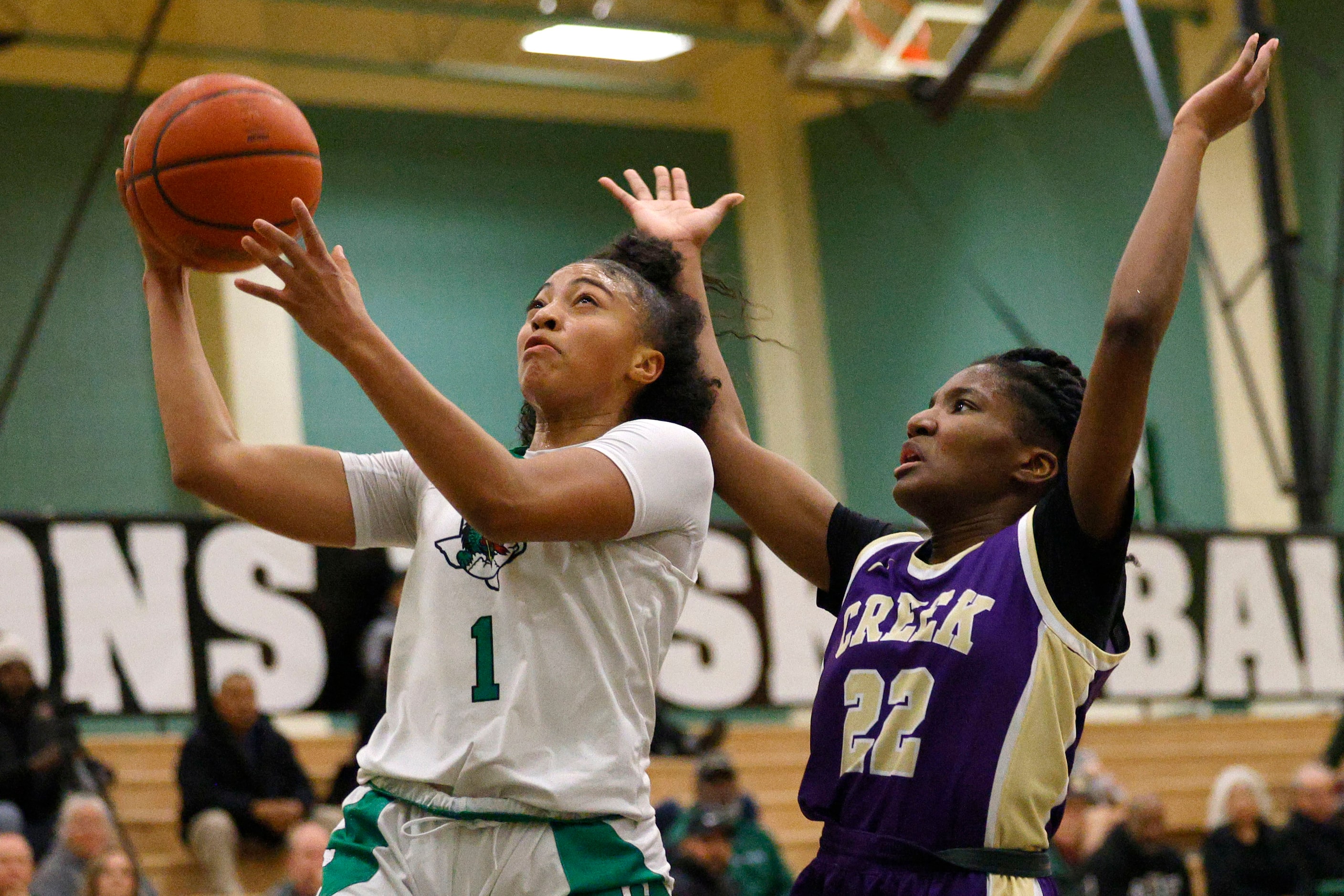 Southlake Carroll's Milania Jordan (1) attempts a jump shot as Keller Timber Creek's London...