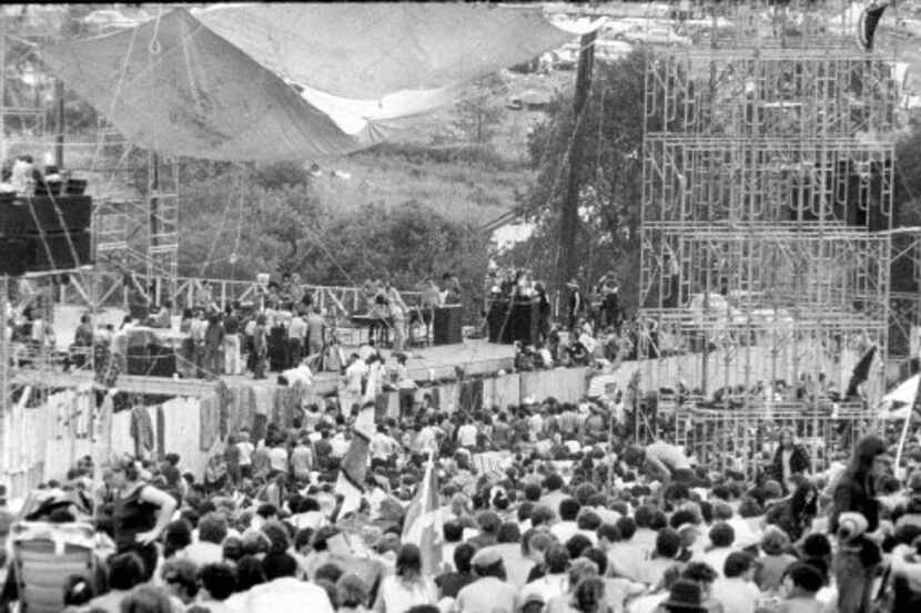 A crowd gathers at the stage set up for the Woodstock Music and Art Fair on the great ...