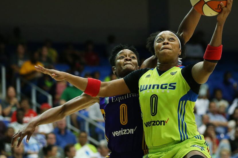 Dallas Wings guard Odyssey Sims (0) shoots a ball over Los Angeles Sparks guard Alana Beard...