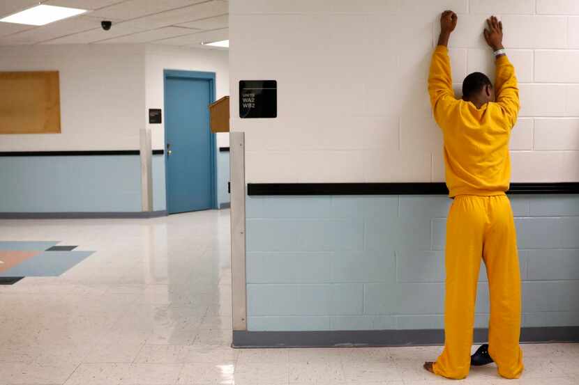 
A juvenile inmate places his hands against the wall for a routine search following...