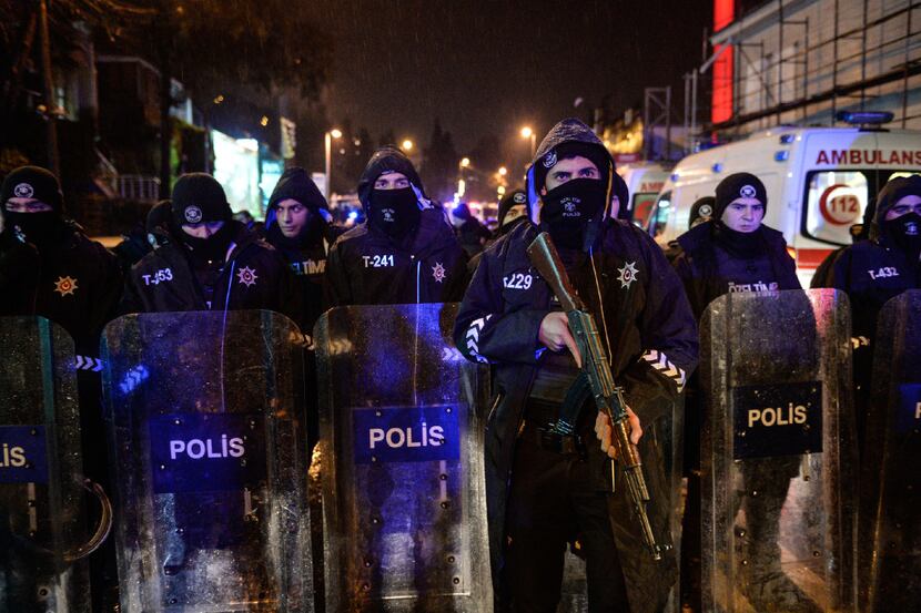 Turkish police officers block the road leading to the scene of an attack in Istanbul, early...