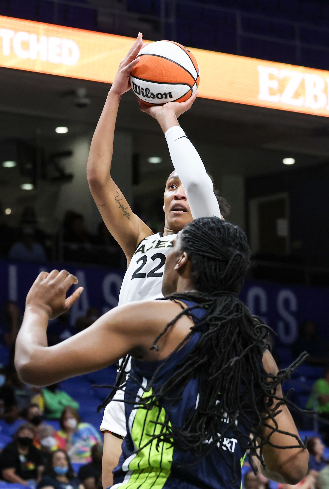 Las Vegas Aces forward A'ja Wilson (22) shoots as Dallas Wings center Teaira McCowan (7)...