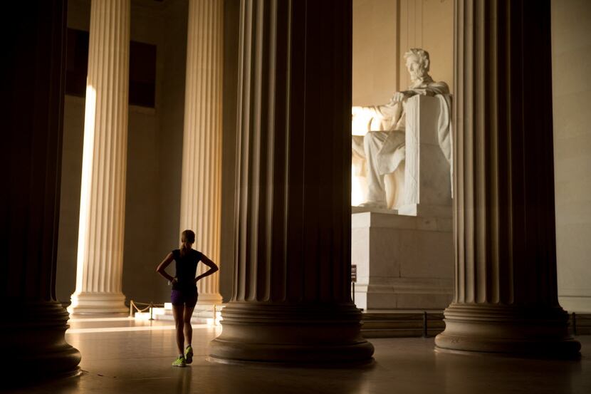 In this May 25, 2016 photo, a runner takes a break and looks around the Lincoln Memorial, in...