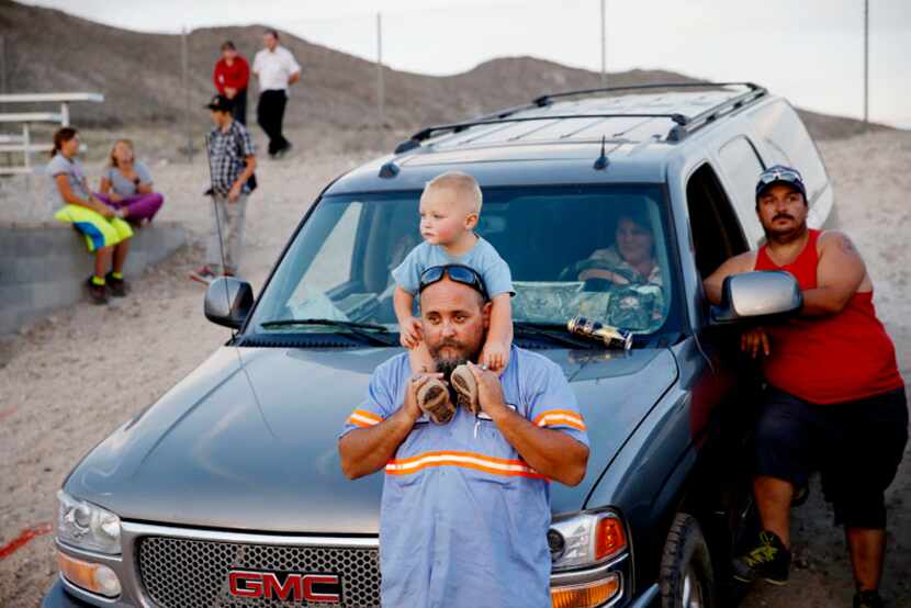  Rick Abbasi, of Tonopah, Nevada, holds onto his son, Carson Abbasi, 1 year old, while...