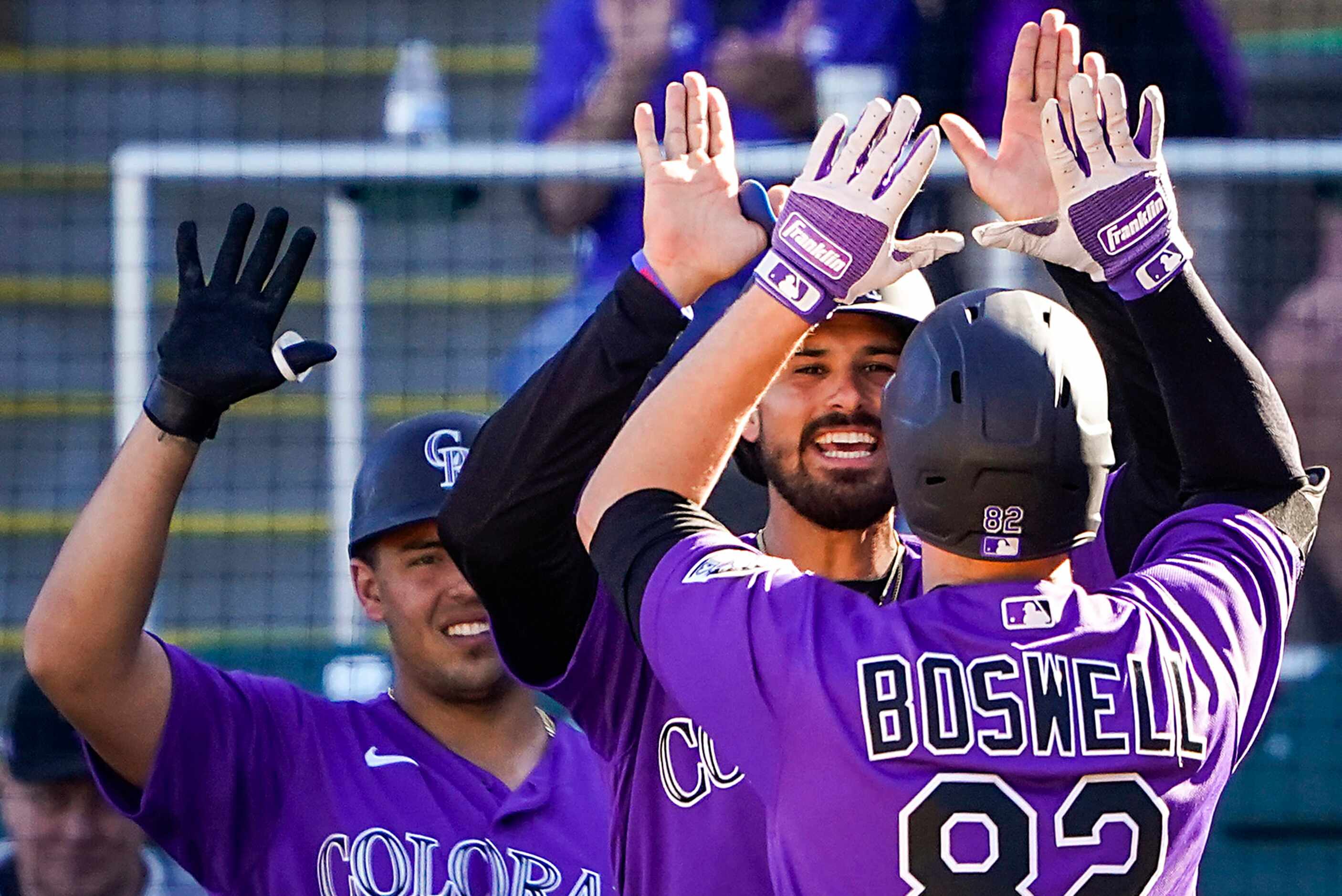 Colorado Rockies outfielder Bret Boswell (82) celebrates with third baseman Josh Fuentes...