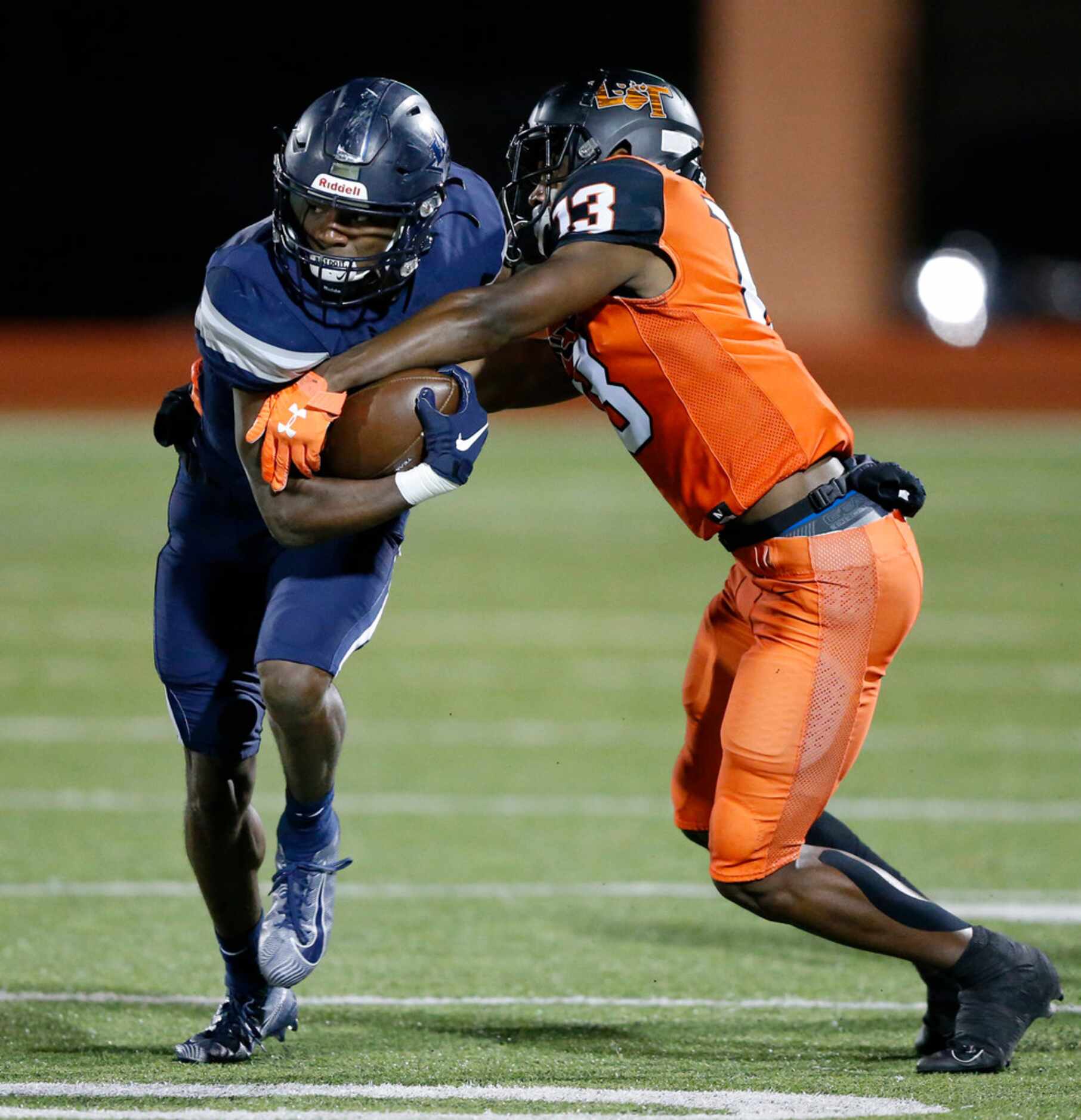 Frisco Lone Star wide receiver Marvin Mims (8) ls tackled by Lancaster defensive back Theron...