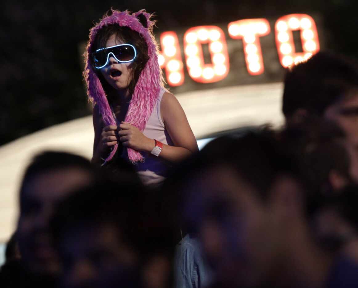 2 1/2-yr-old Sydney McKane gets a better view of the show during Homegrown Music & Arts...