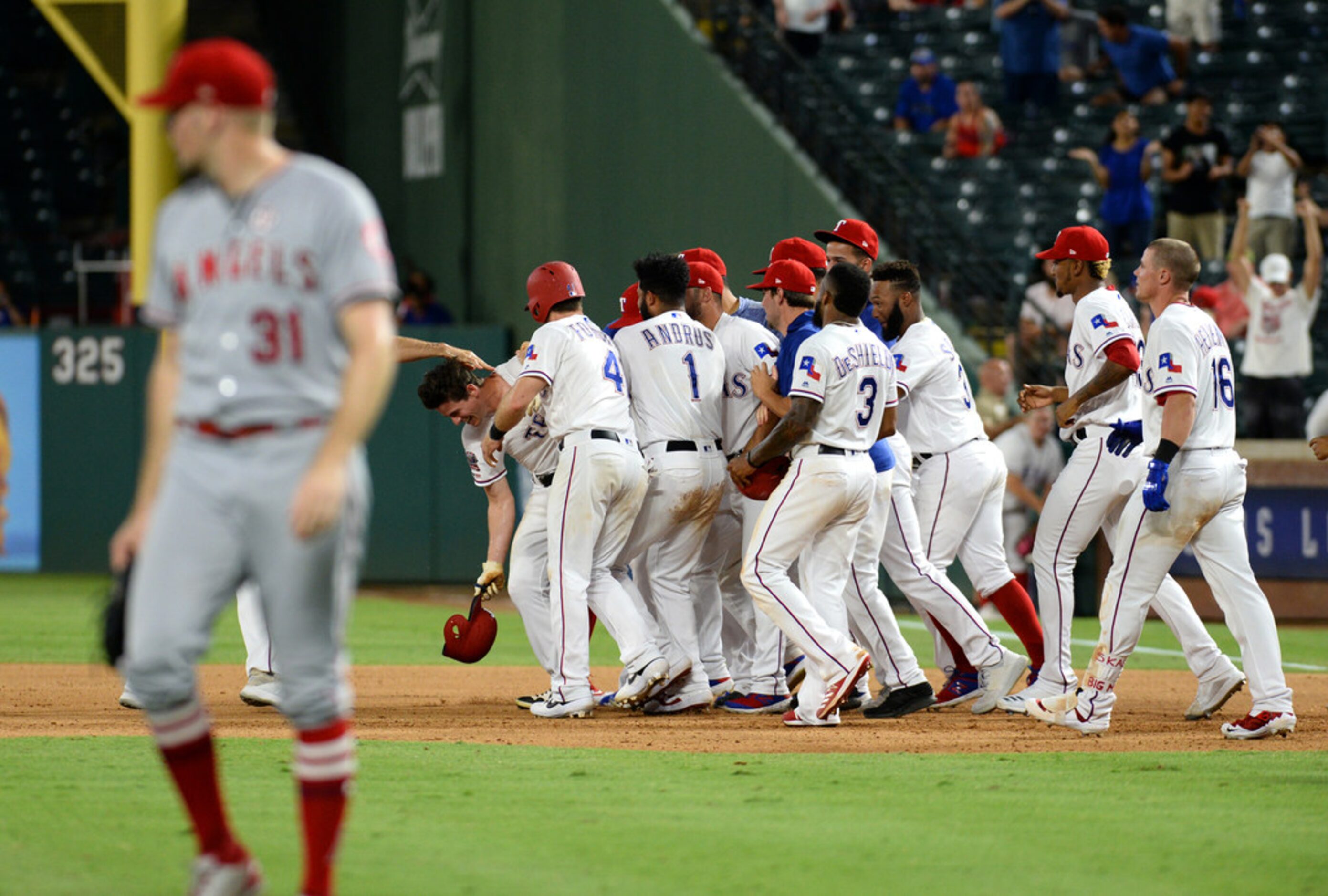 ARLINGTON, TEXAS - AUGUST 20: Nick Solak #15 of the Texas Rangers celebrates with his...