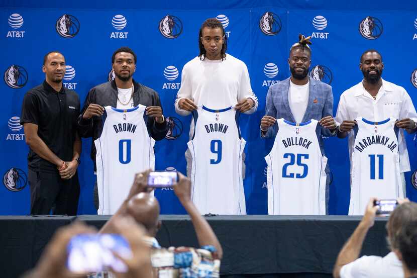 (L to R) Dallas Mavericks General Manager Nico Harrison, forwards Sterling Brown, Moses...