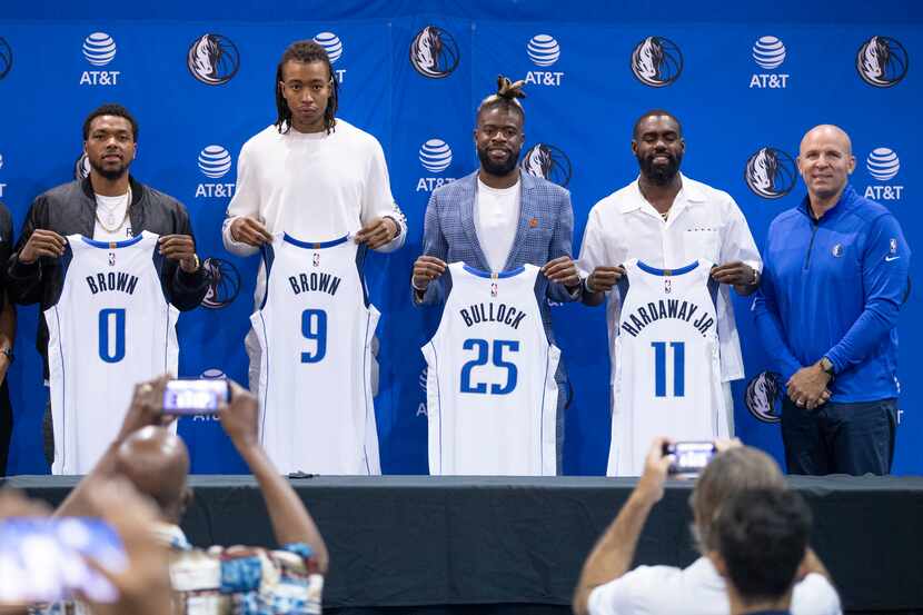 (L to R) Dallas Mavericks General Manager Nico Harrison, forwards Sterling Brown, Moses...