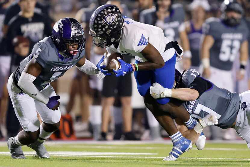 Mansfield Summit wide receiver Kerya Powell (2) is pulled down by College Station defensive...