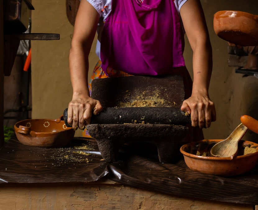 Traditionally, the grinding is done on a metate, a stone instrument consisting of a slightly...