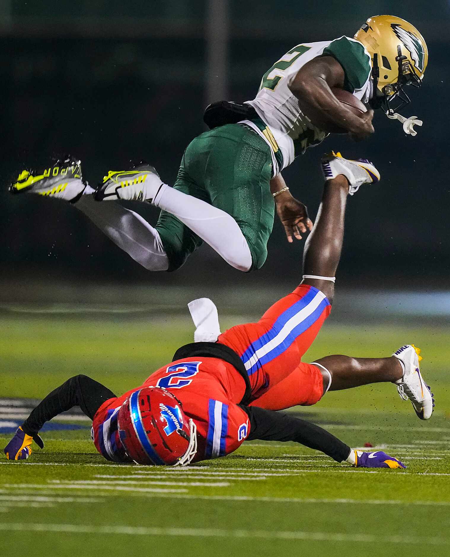 DeSoto running back Deondrae Riden Jr. (22) is knocked off his feet by Duncanville defensive...