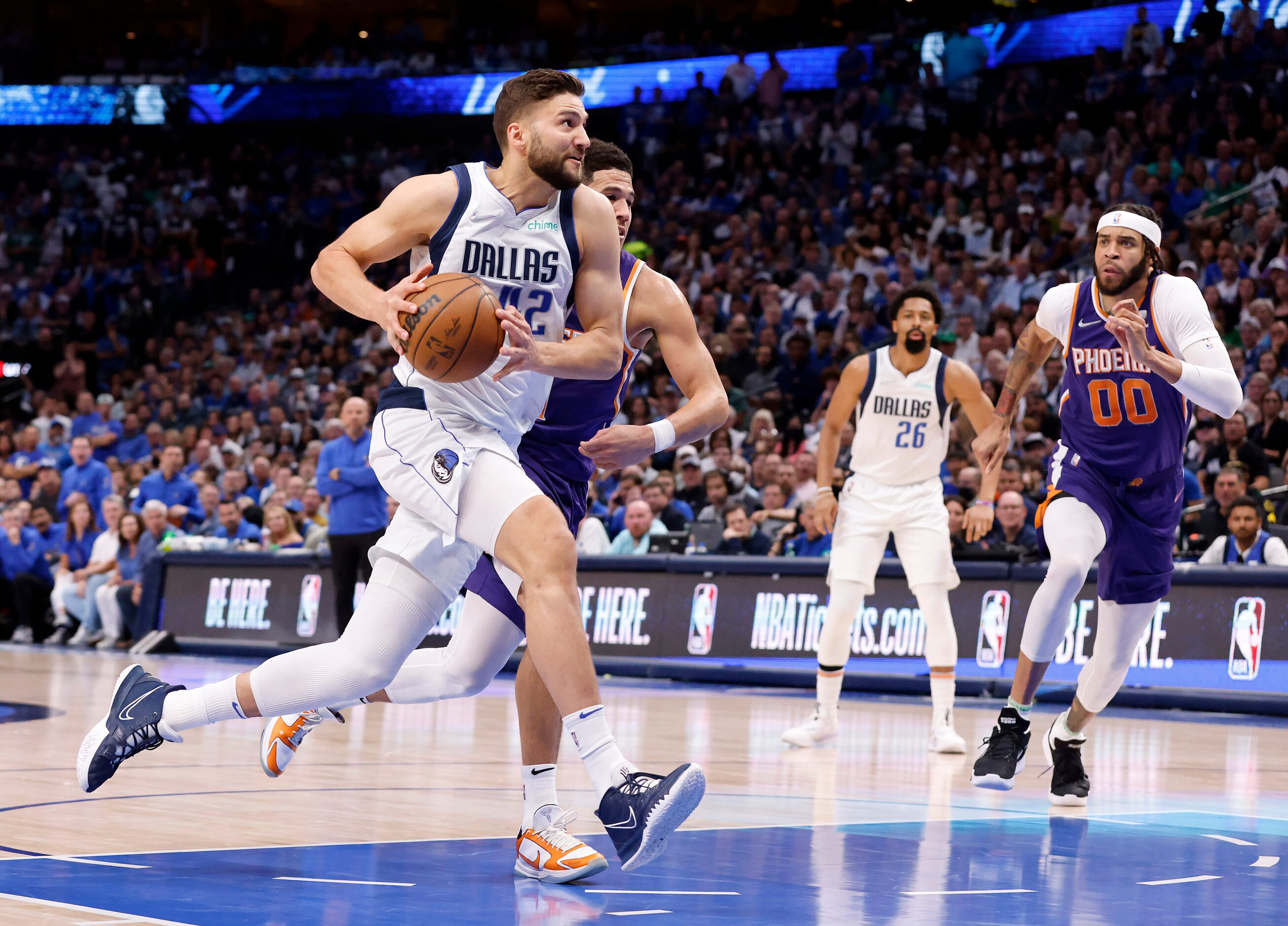 Dallas Mavericks forward Maxi Kleber (42) drives hard to the basket against Phoenix Suns...