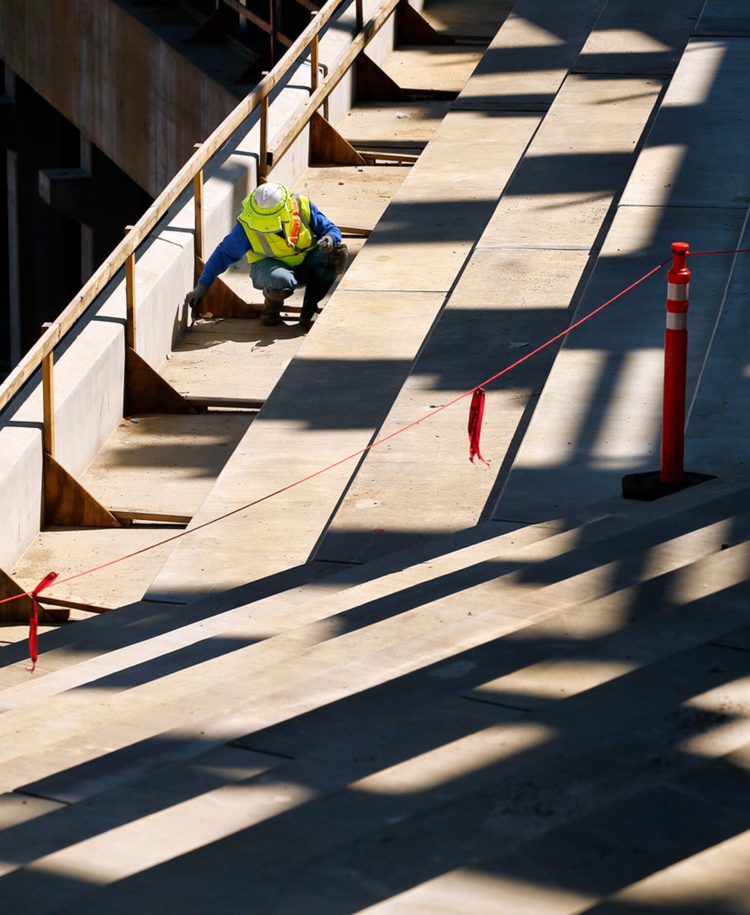 Hernando Castillo works on the main concourse seating area at the new Globe Life Field under...