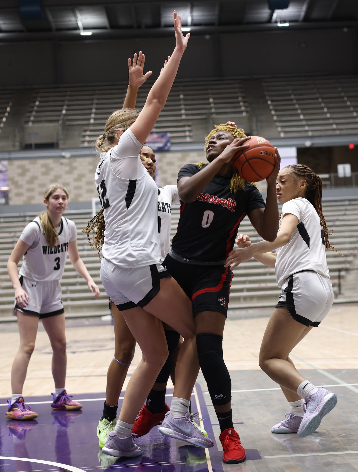 Denton Braswell guard Ytaly Lewis (9), center right, looks to shoot as she is defended by...