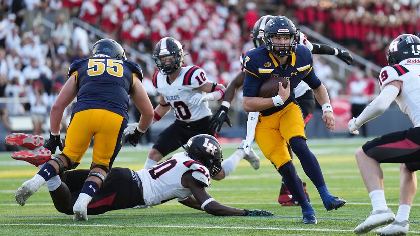 Highland Park quarterback Brennan Storer (7) scrambles for a first down through the Lake...