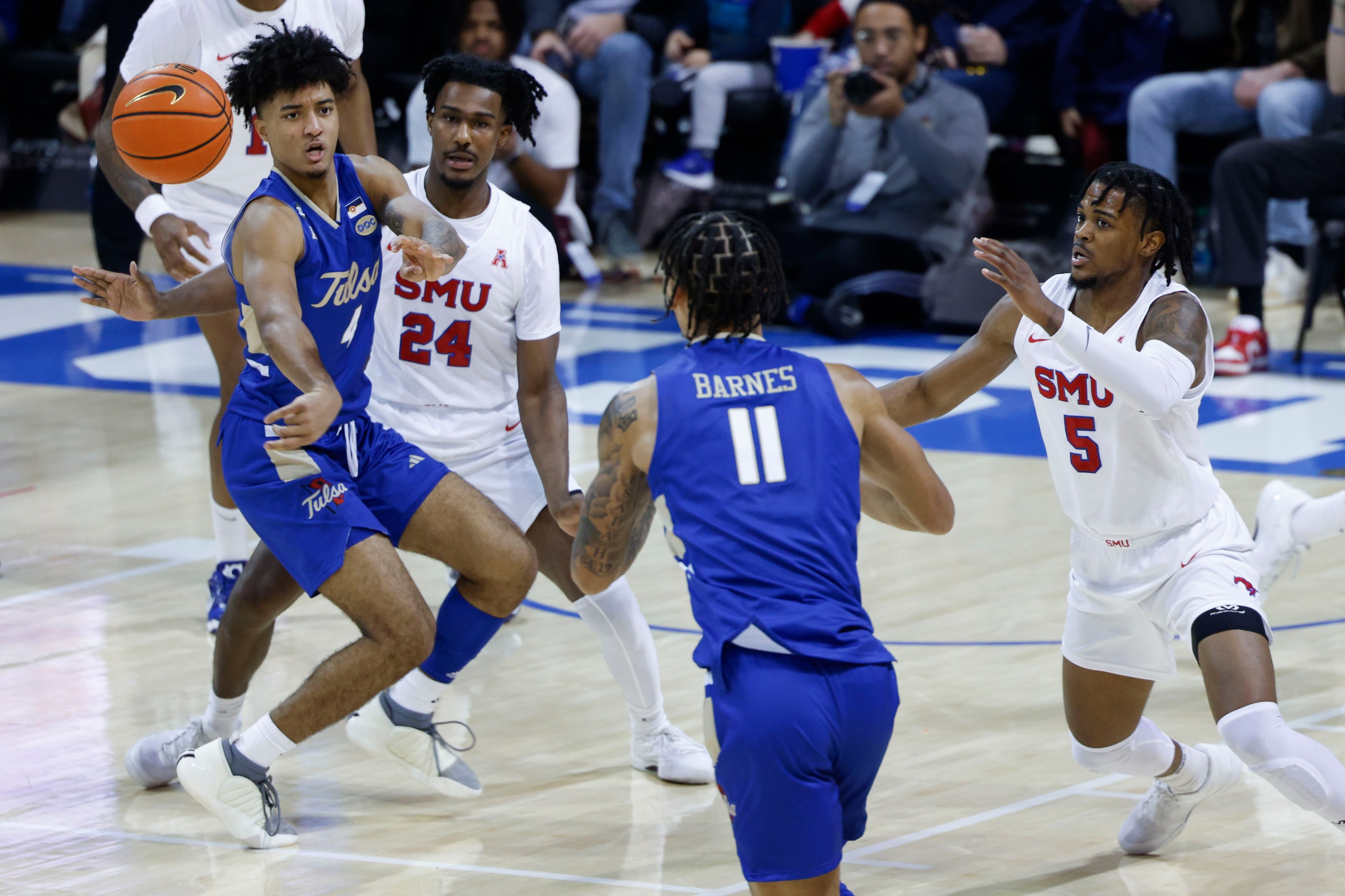 Tulsa guard PJ Haggerty (left) passes the ball to guard Isaiah Barnes (11) as Southern...