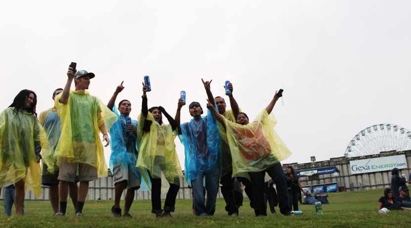 Concert-goers brave the rain, complete with beer and ponchos, during a 2012 festival at Gexa...