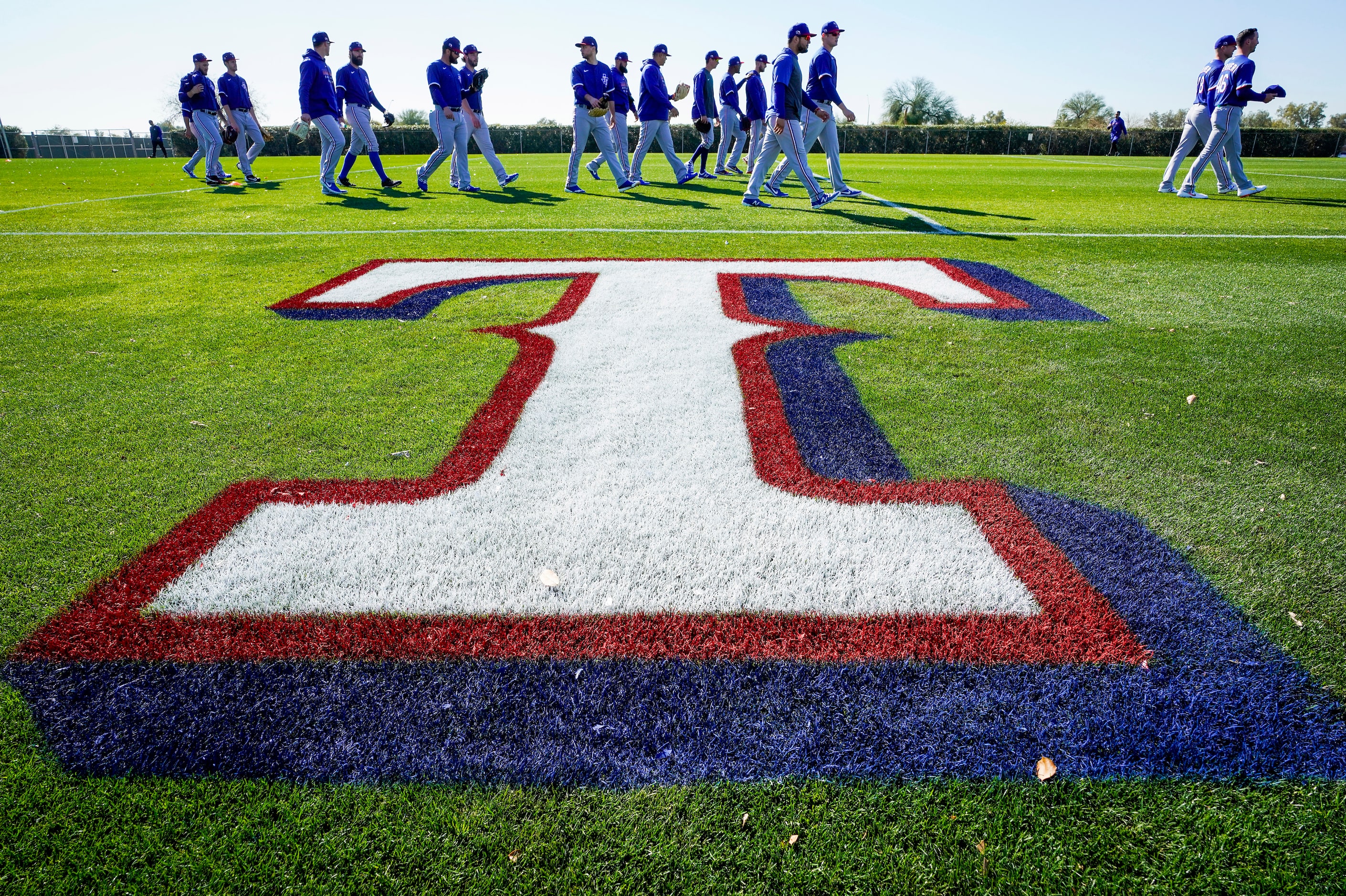 Texas Rangers players head to their first drills during the first spring training workout...