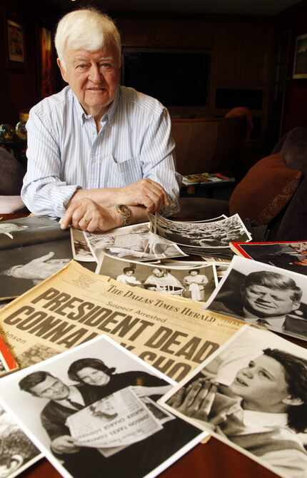 Former Dallas Times Herald photographer Eamon Kennedy with some of his JFK photographs in a...