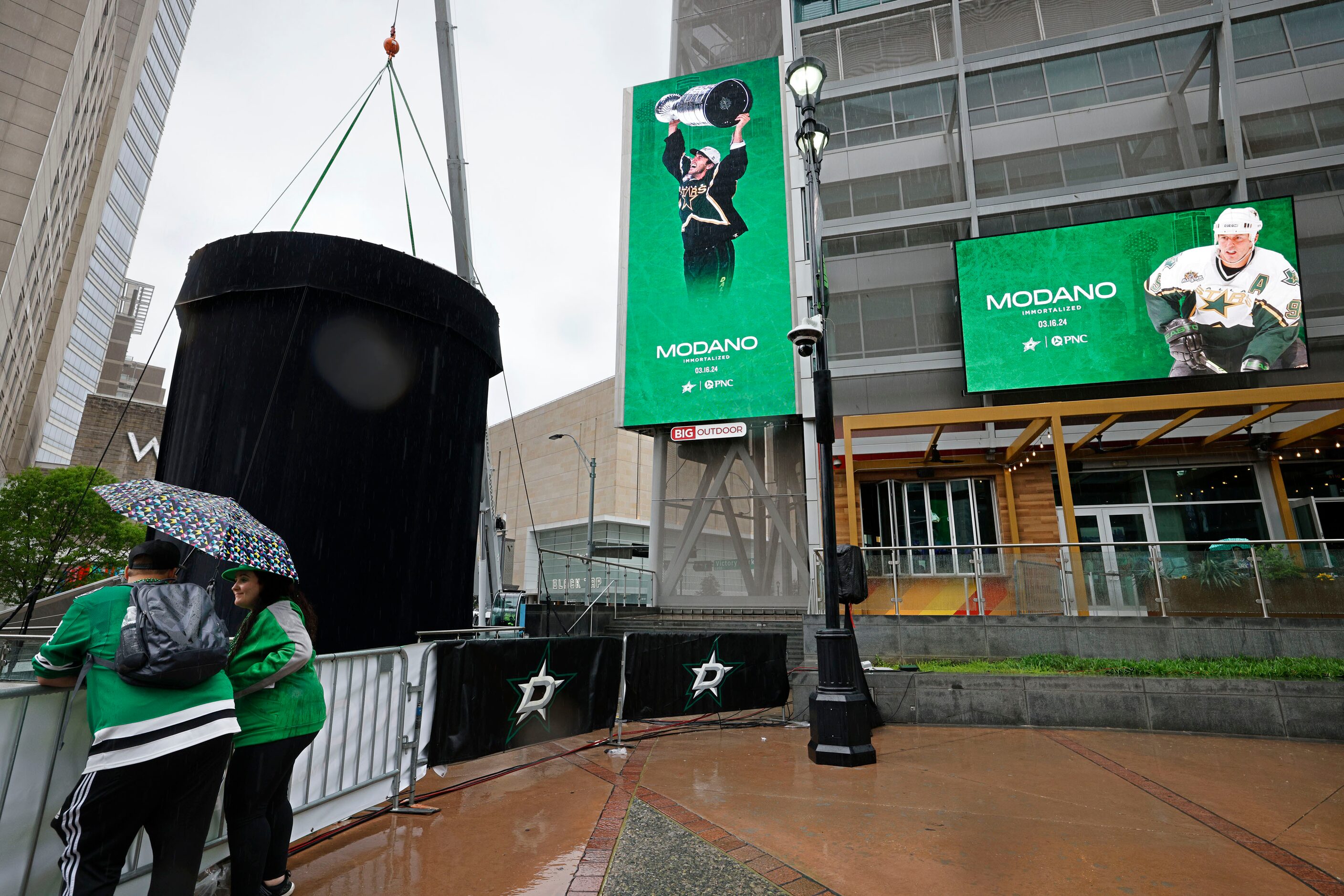 Dallas Stars fans Max Vaughan of Houston and his wife Jessica Vaughan stand in the rain in...